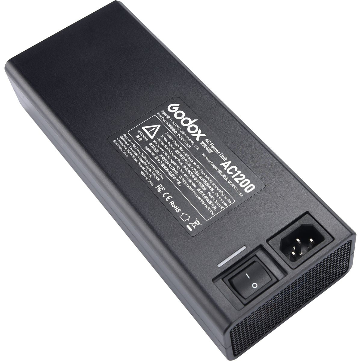 Adaptateur secteur Godox AC1200 posé à plat, prise secteur et interrupteur en bout